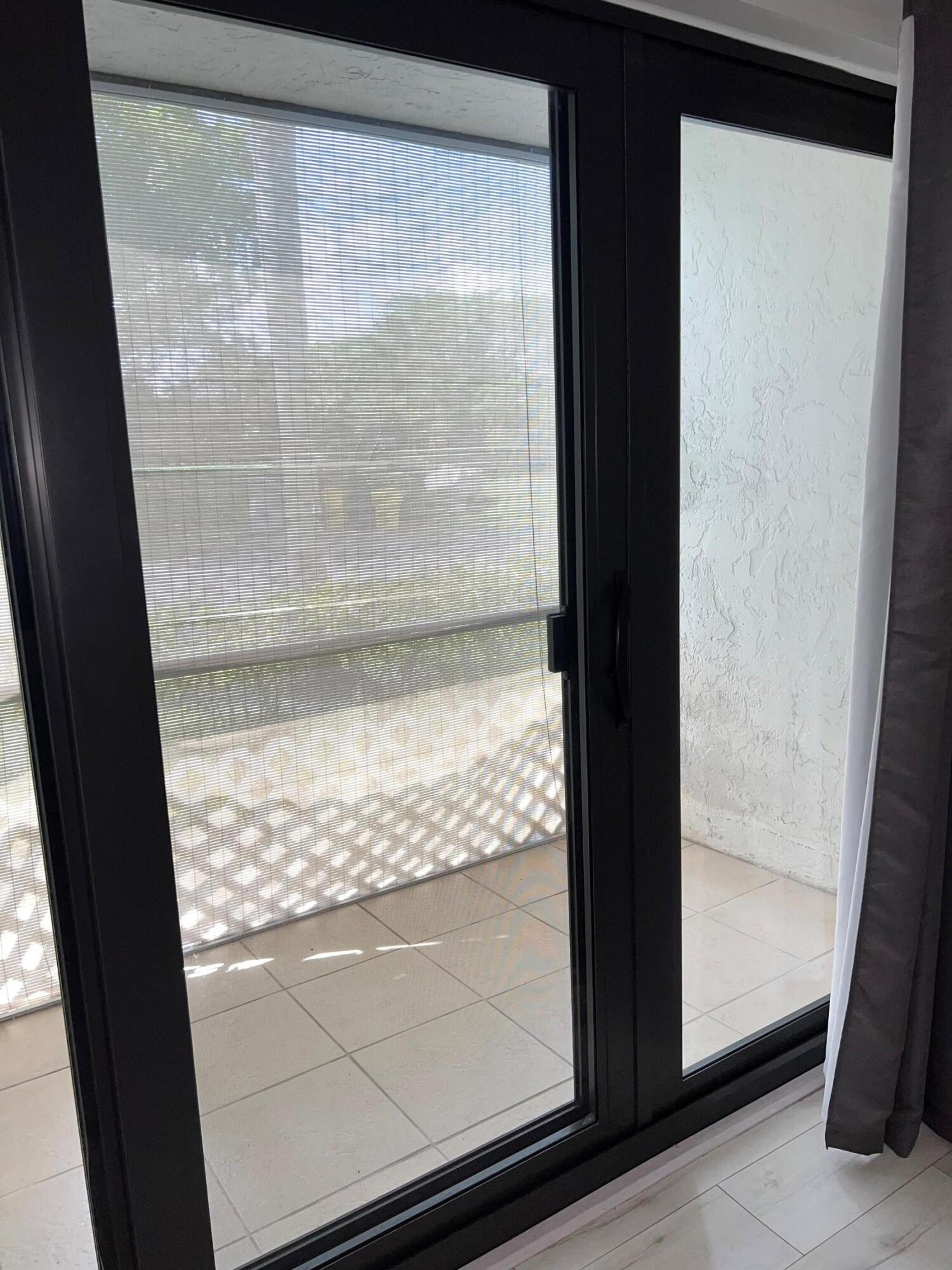 1006 Green Pine Boulevard, Unit A1 West Palm Beach, FL 33409 - Photo 8 of 25 a view of a glass door