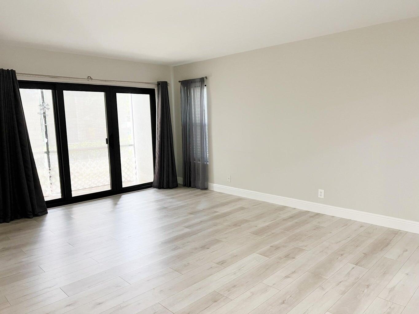 1006 Green Pine Boulevard, Unit A1 West Palm Beach, FL 33409 - Photo 9 of 25 a view of a black and white wall with wooden floor