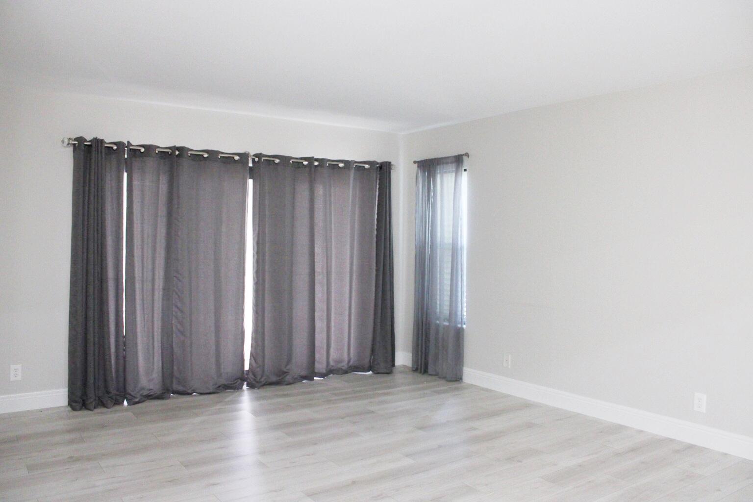 1006 Green Pine Boulevard, Unit A1 West Palm Beach, FL 33409 - Photo 10 of 25 an empty room with wooden floor and closet