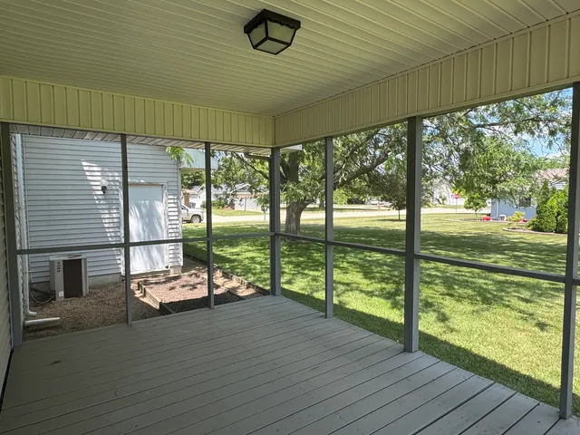 a sitting area with swimming pool in front of it