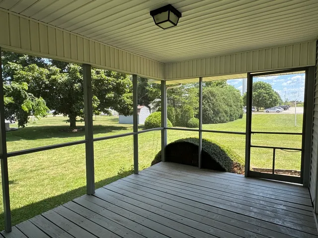 a view of a balcony with wooden floor