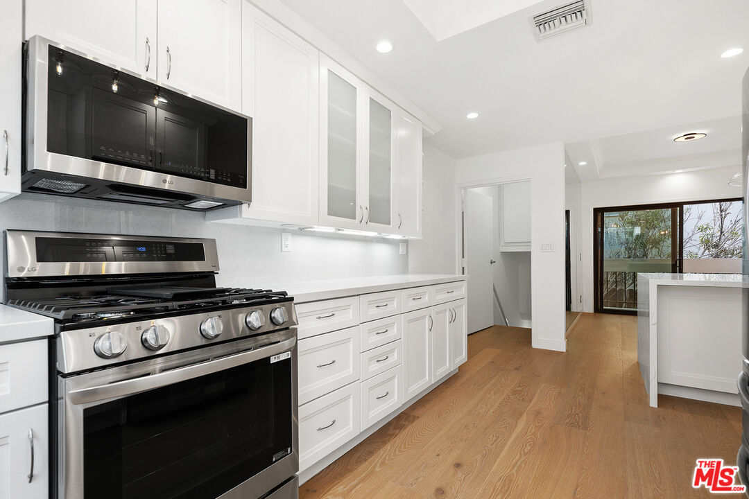 234 South Tower Drive, Unit 2 Beverly Hills, CA 90211 - Photo 20 of 54 a kitchen with stainless steel appliances a stove microwave and cabinets