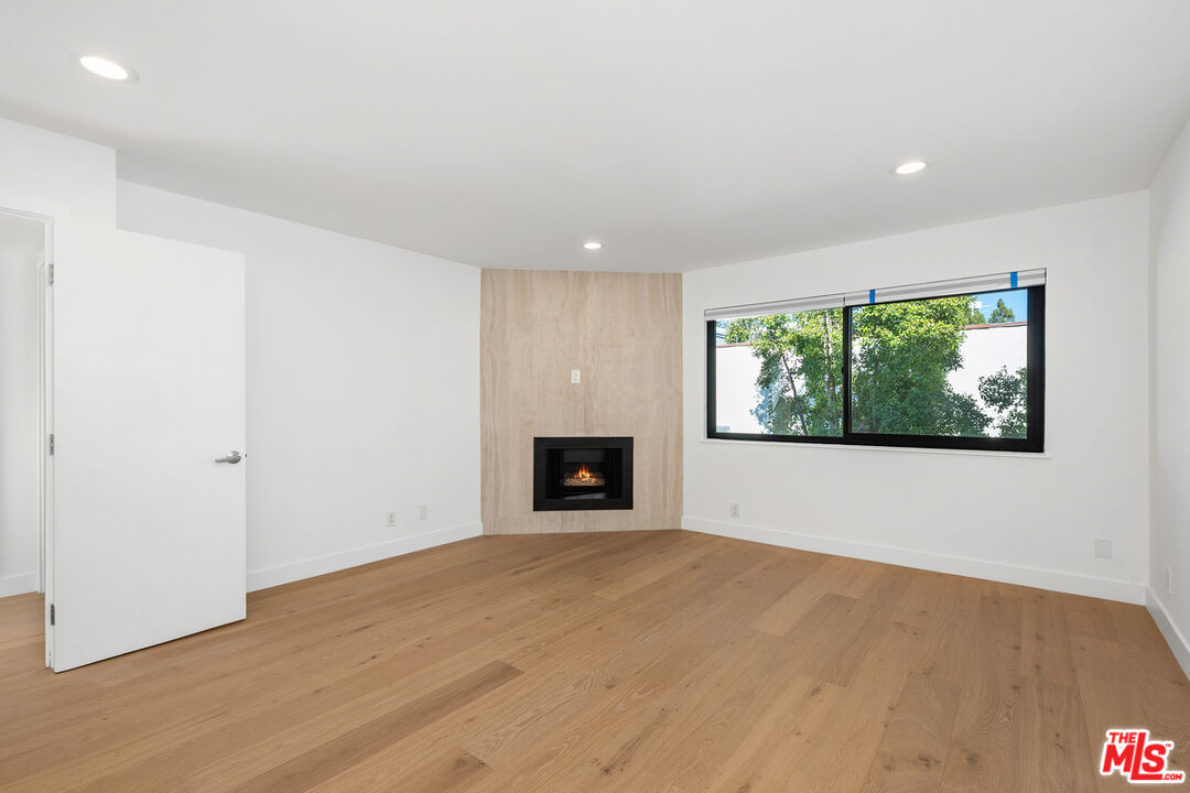 234 South Tower Drive, Unit 2 Beverly Hills, CA 90211 - Photo 40 of 54 a view of an empty room with a window and fire place