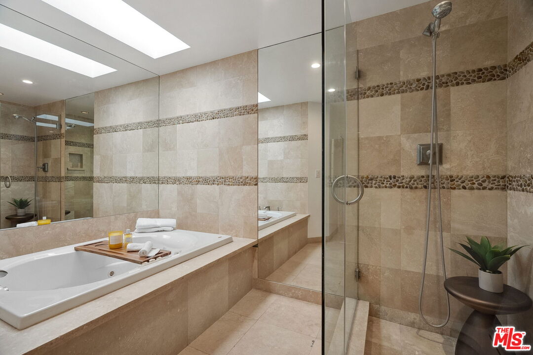 234 South Tower Drive, Unit 2 Beverly Hills, CA 90211 - Photo 42 of 54 a bathroom with a tub and a shower