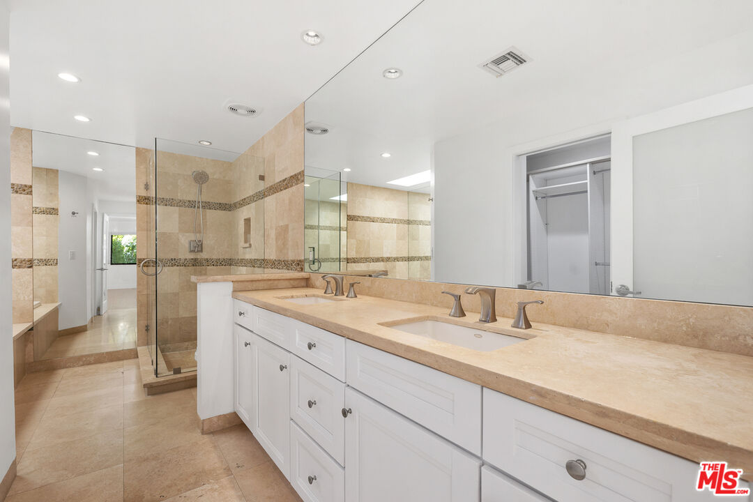 234 South Tower Drive, Unit 2 Beverly Hills, CA 90211 - Photo 45 of 54 a bathroom with a sink double vanity granite tub shower and a mirror