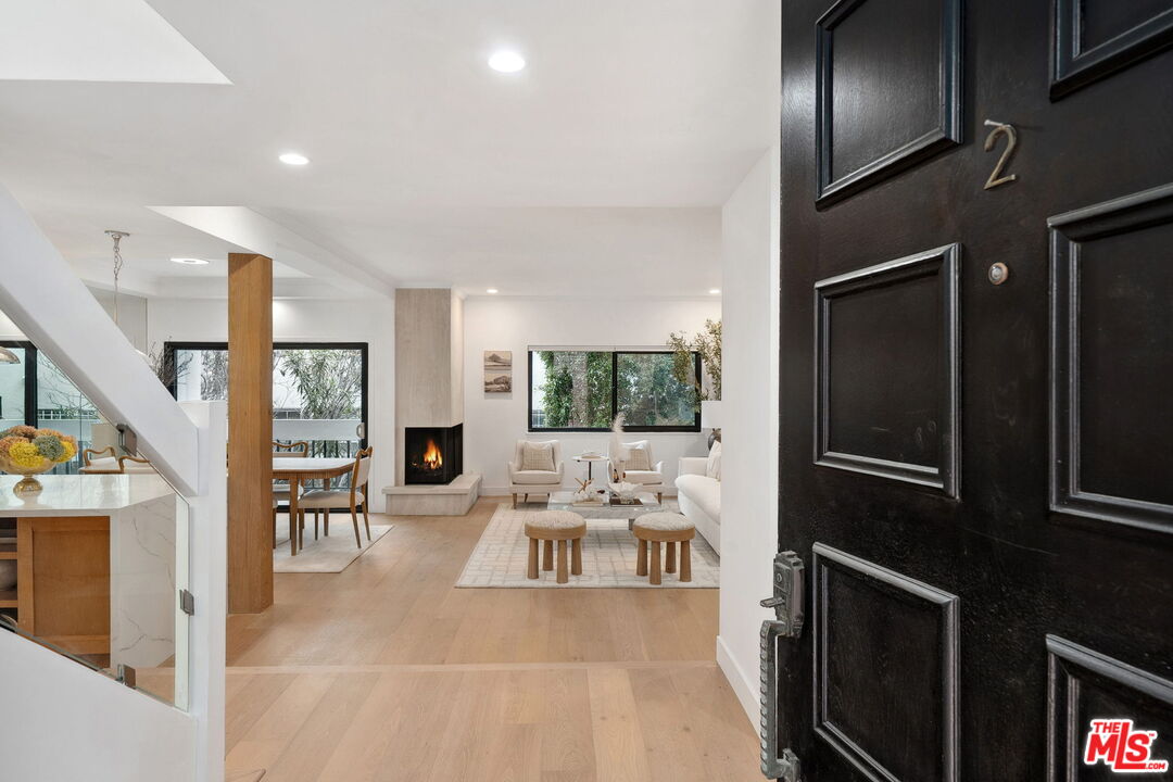 234 South Tower Drive, Unit 2 Beverly Hills, CA 90211 - Photo 5 of 54 a living room with furniture a fireplace and a flat screen tv