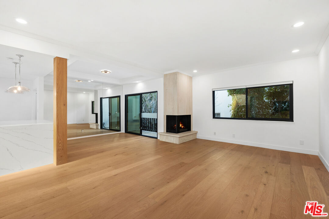 234 South Tower Drive, Unit 2 Beverly Hills, CA 90211 - Photo 9 of 54 a view of an empty room with wooden floor and a window