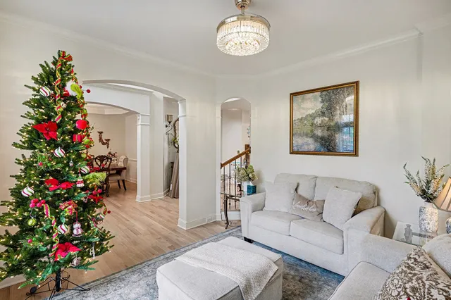 a view of a dining room with furniture and chandelier