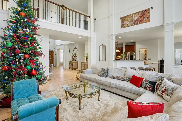 a living room with furniture and flowers