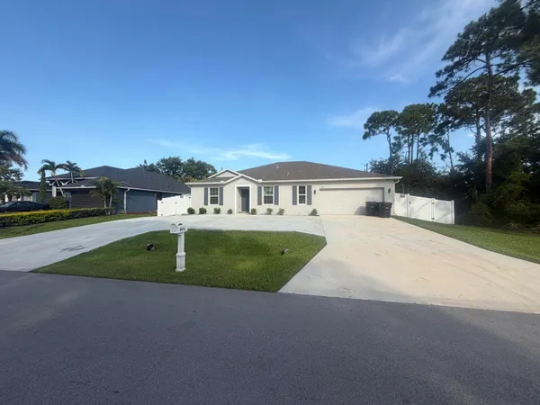 a view of house with outdoor space and parking