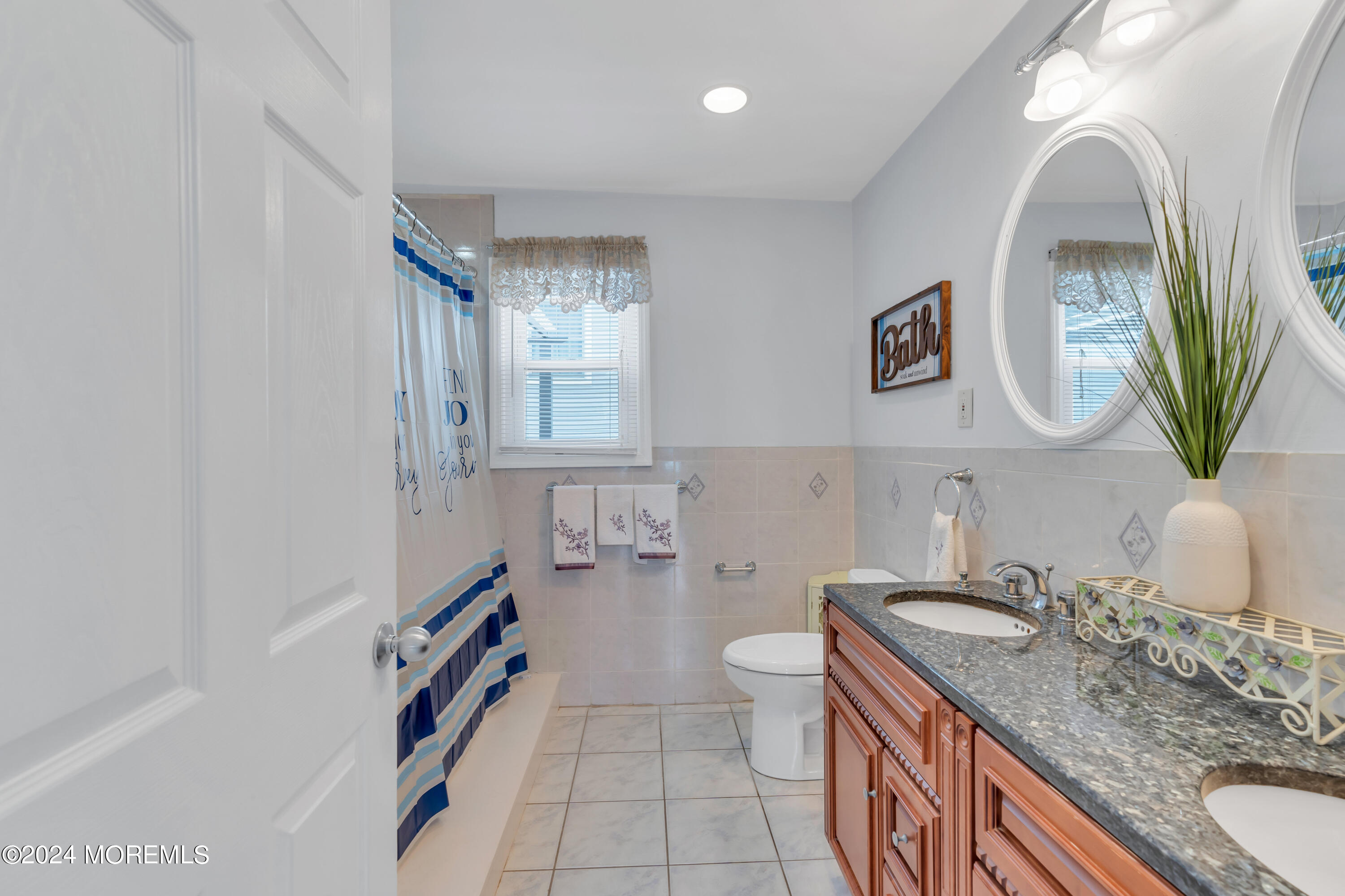 117 Harding Avenue Seaside Heights, NJ 08751 - Photo 20 of 28 a bathroom with a granite countertop sink and a mirror