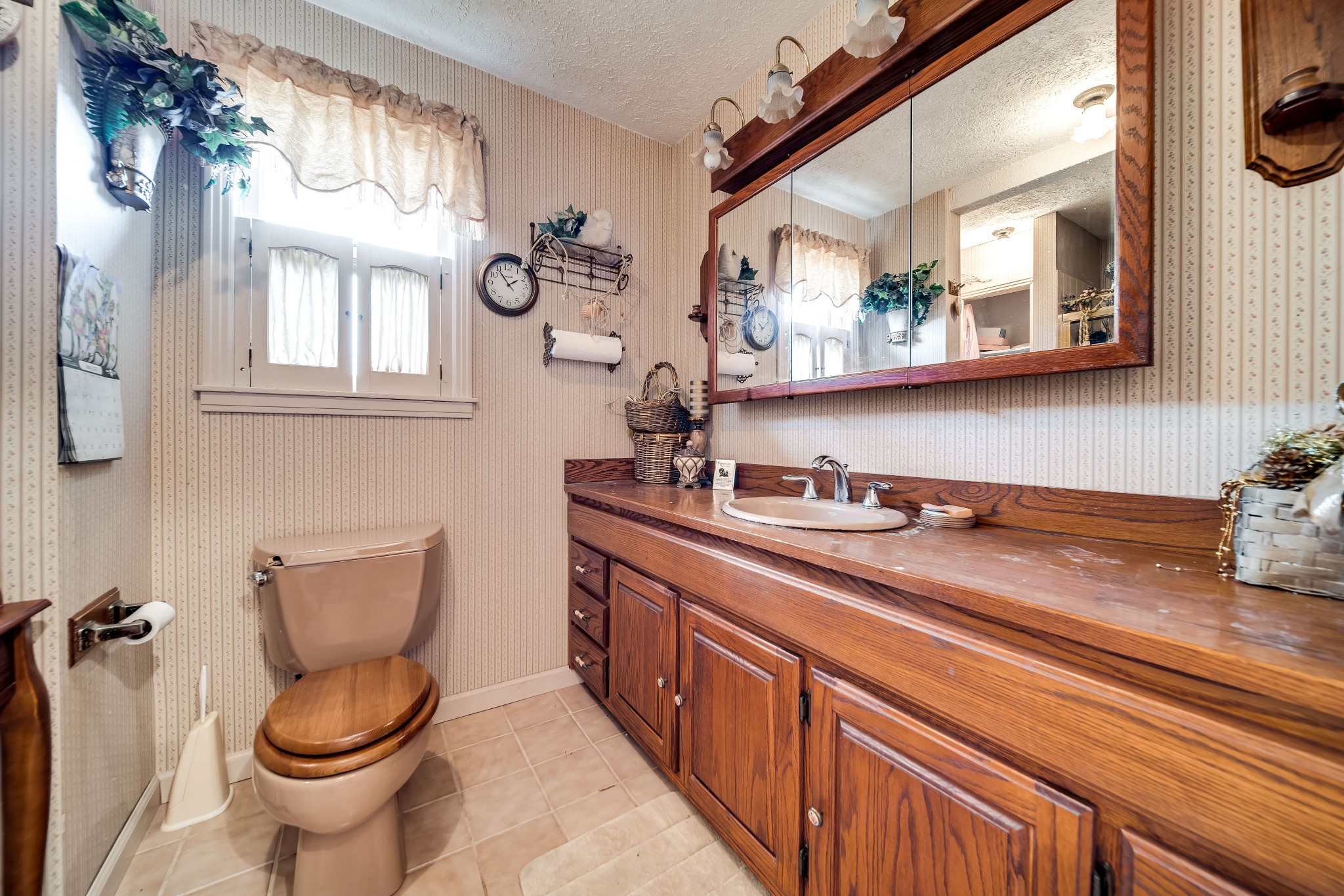 6040 New Cut Road Springfield, TN 37172 - Photo 20 of 37 a bathroom with a granite countertop toilet sink and mirror