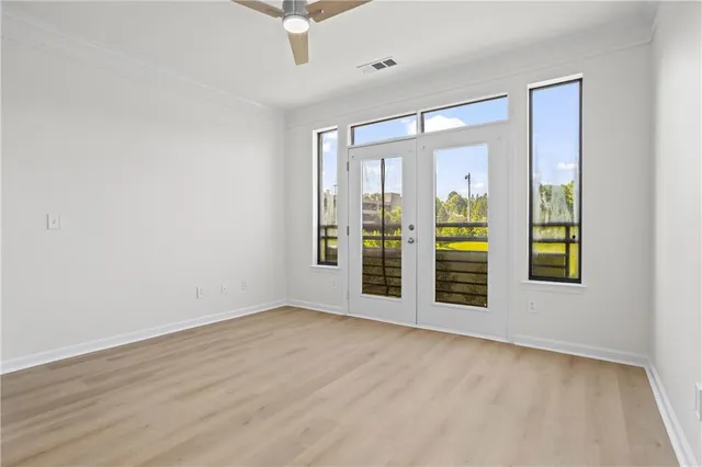 an empty room with windows and entrance