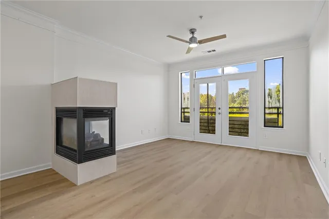 a view of an empty room with a fireplace and a window