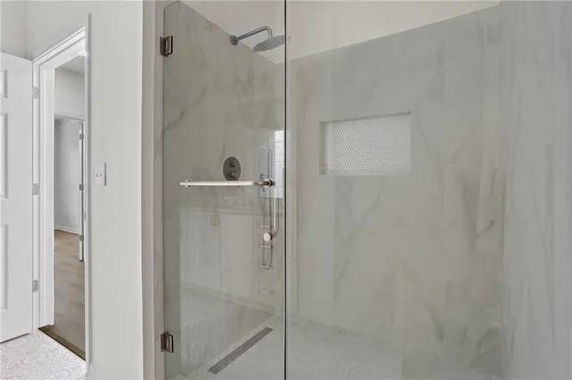 a bathroom with a glass shower door
