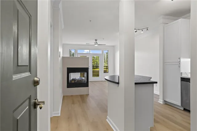 a view of a hallway with wooden floor and a fireplace