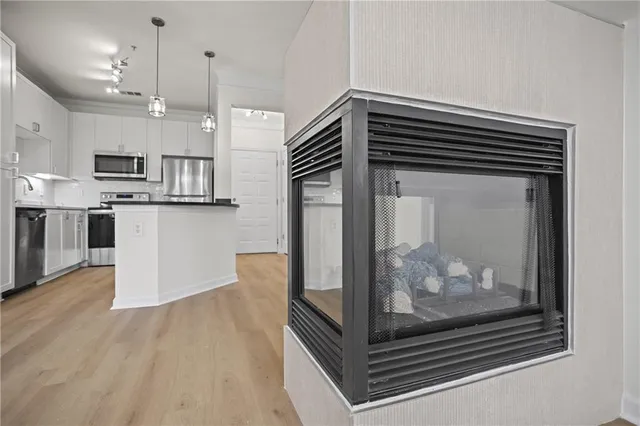 a kitchen with stainless steel appliances a stove a microwave and a refrigerator