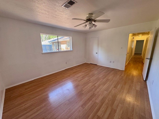 2006 Seagate Lane Houston, TX 77062 - Photo 12 of 22 a view of an empty room with wooden floor and a ceiling fan