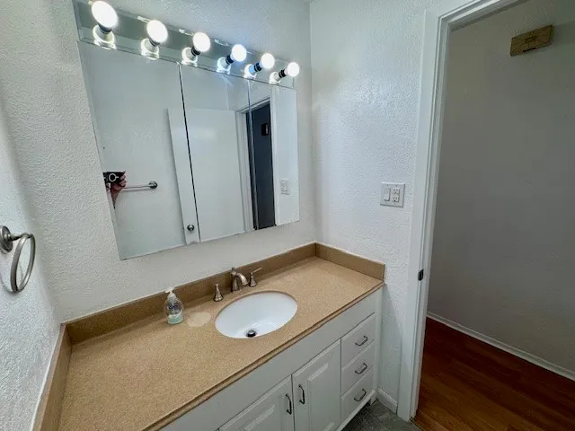 a bathroom with a granite countertop shower and a toilet