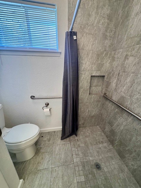 2006 Seagate Lane Houston, TX 77062 - Photo 16 of 22 a bathroom with a toilet and a shower