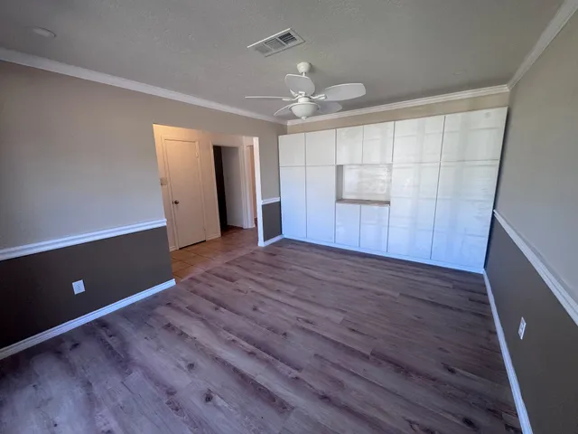 a view of a room with a window and a ceiling fan