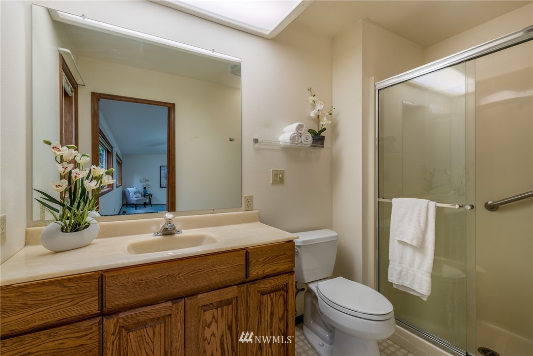 6507 Woodlyn Road Ferndale, WA 98248 - Photo 14 of 25 a bathroom with a sink a toilet and shower