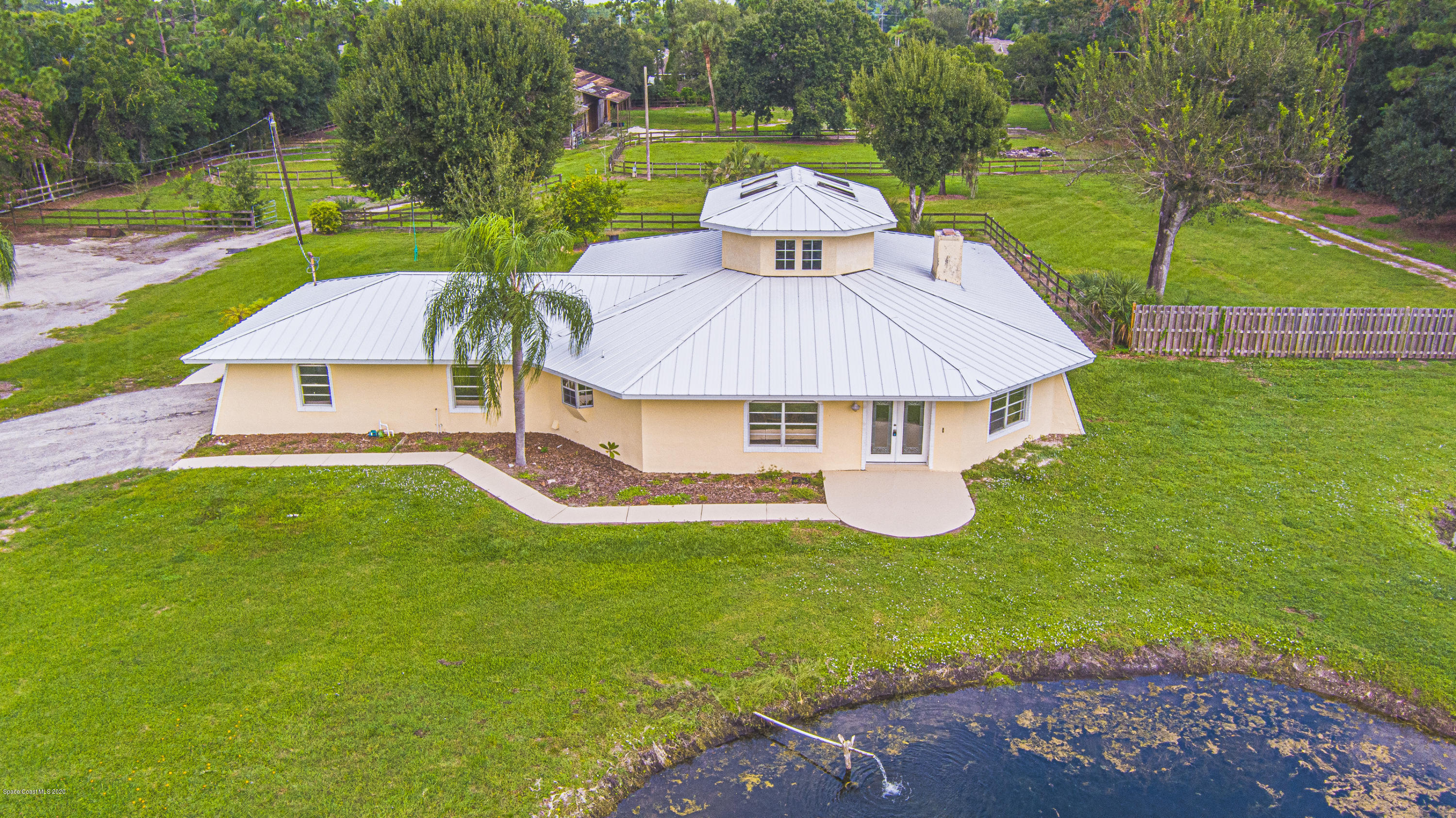 4300 Pinewood Road Melbourne, FL 32934 - Photo 2 of 60 a aerial view of a house with swimming pool and a yard