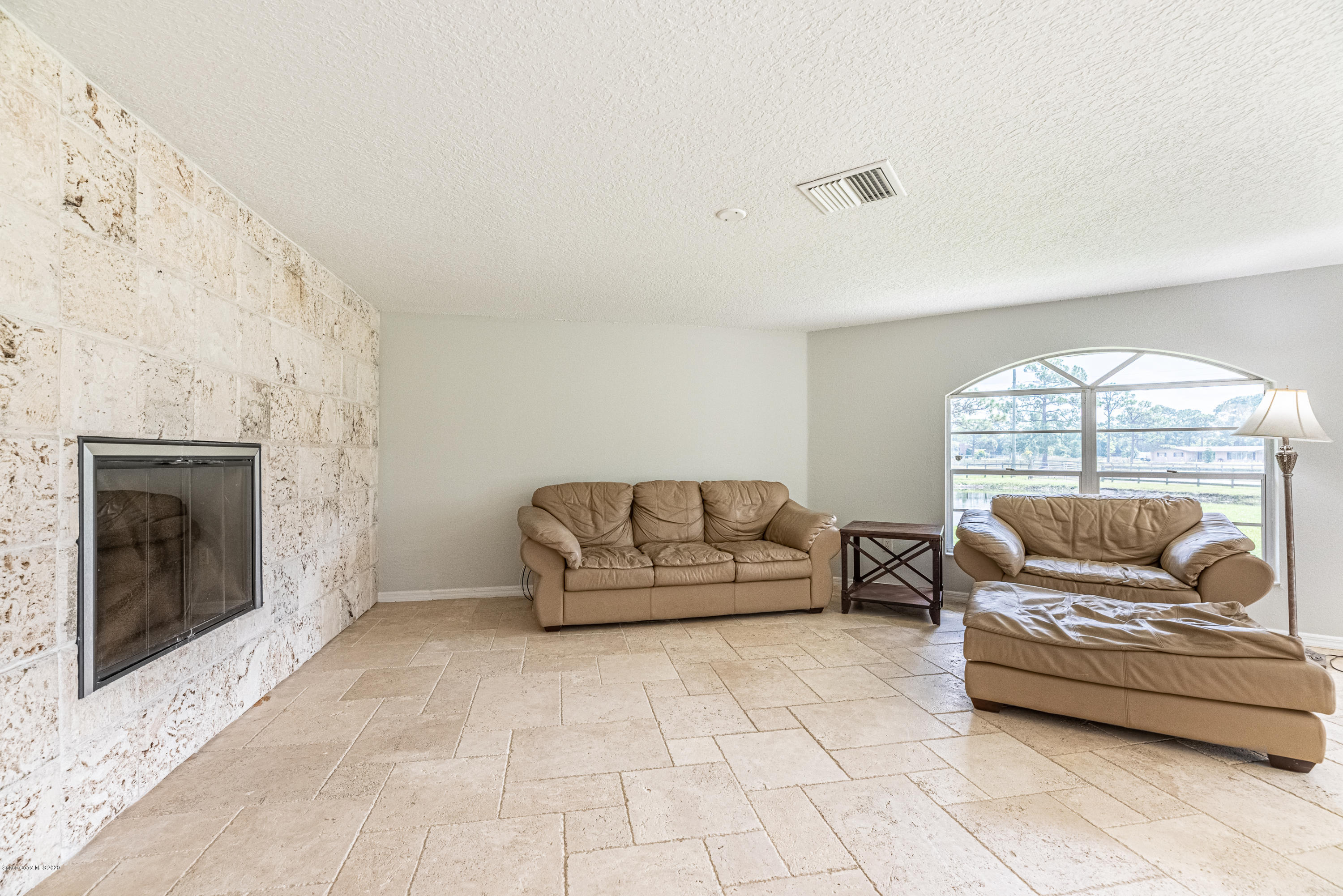4300 Pinewood Road Melbourne, FL 32934 - Photo 11 of 60 a living room with furniture and a fireplace