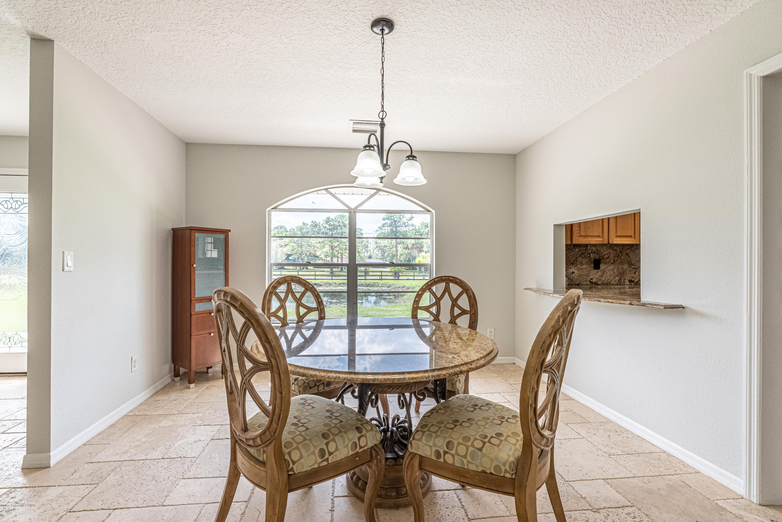 4300 Pinewood Road Melbourne, FL 32934 - Photo 12 of 60 a view of a dining room with furniture window and outside view