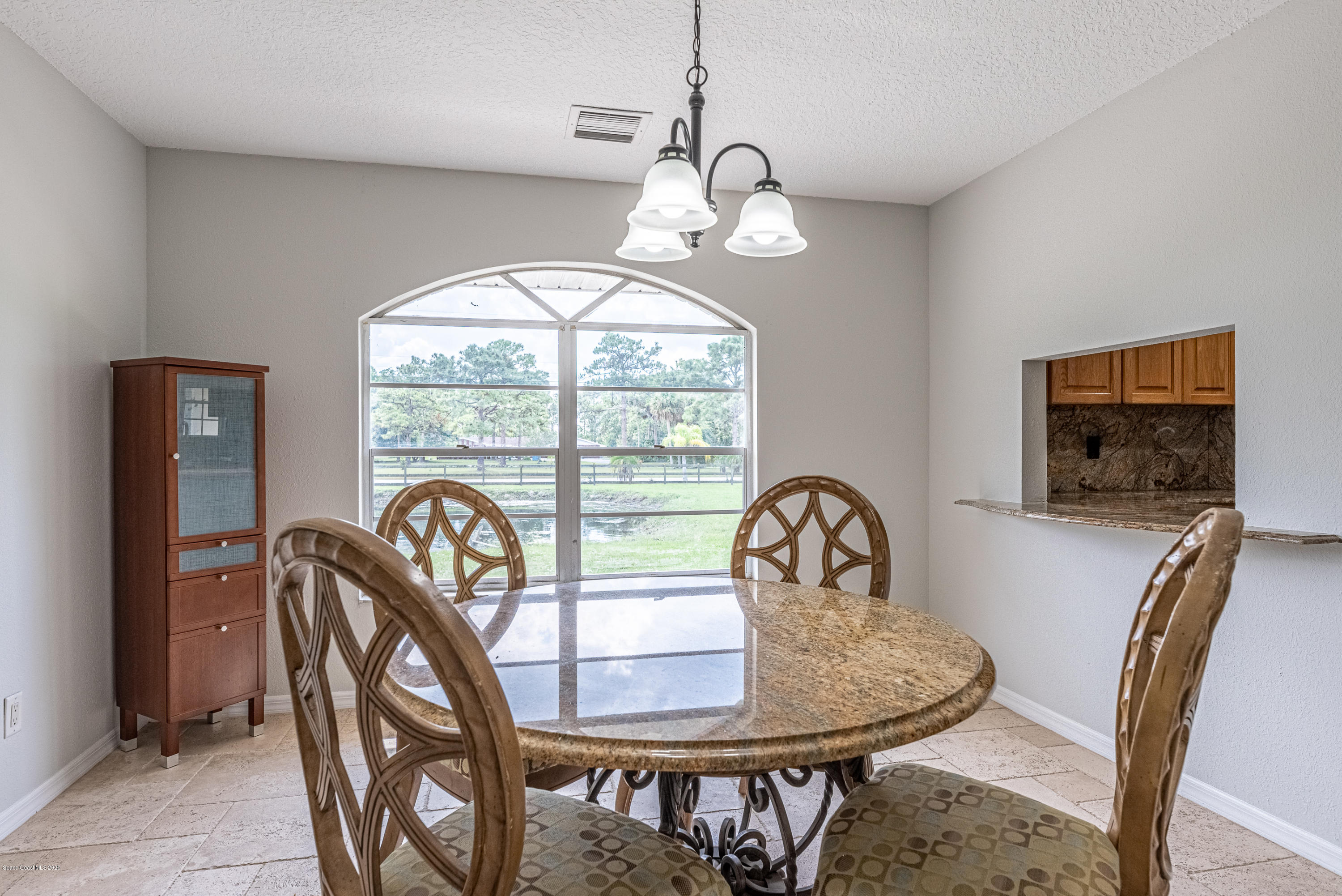 4300 Pinewood Road Melbourne, FL 32934 - Photo 13 of 60 a view of a dining room with furniture window and outside view