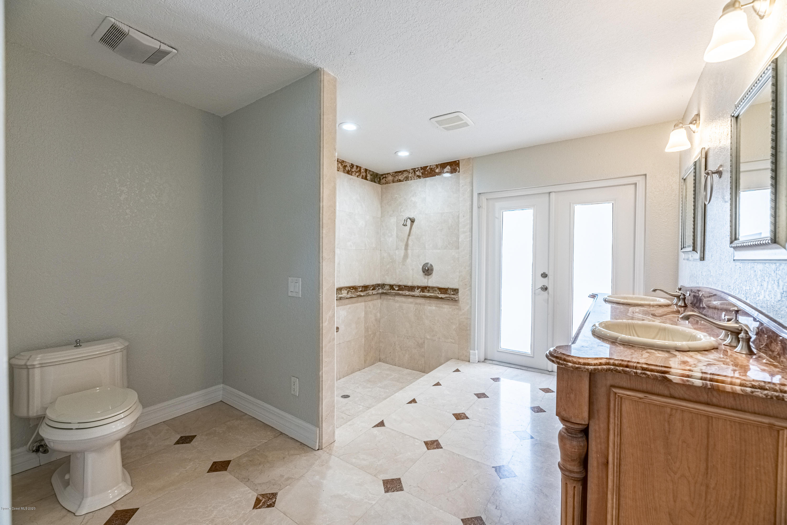 4300 Pinewood Road Melbourne, FL 32934 - Photo 25 of 60 a bathroom with a sink a toilet and shower