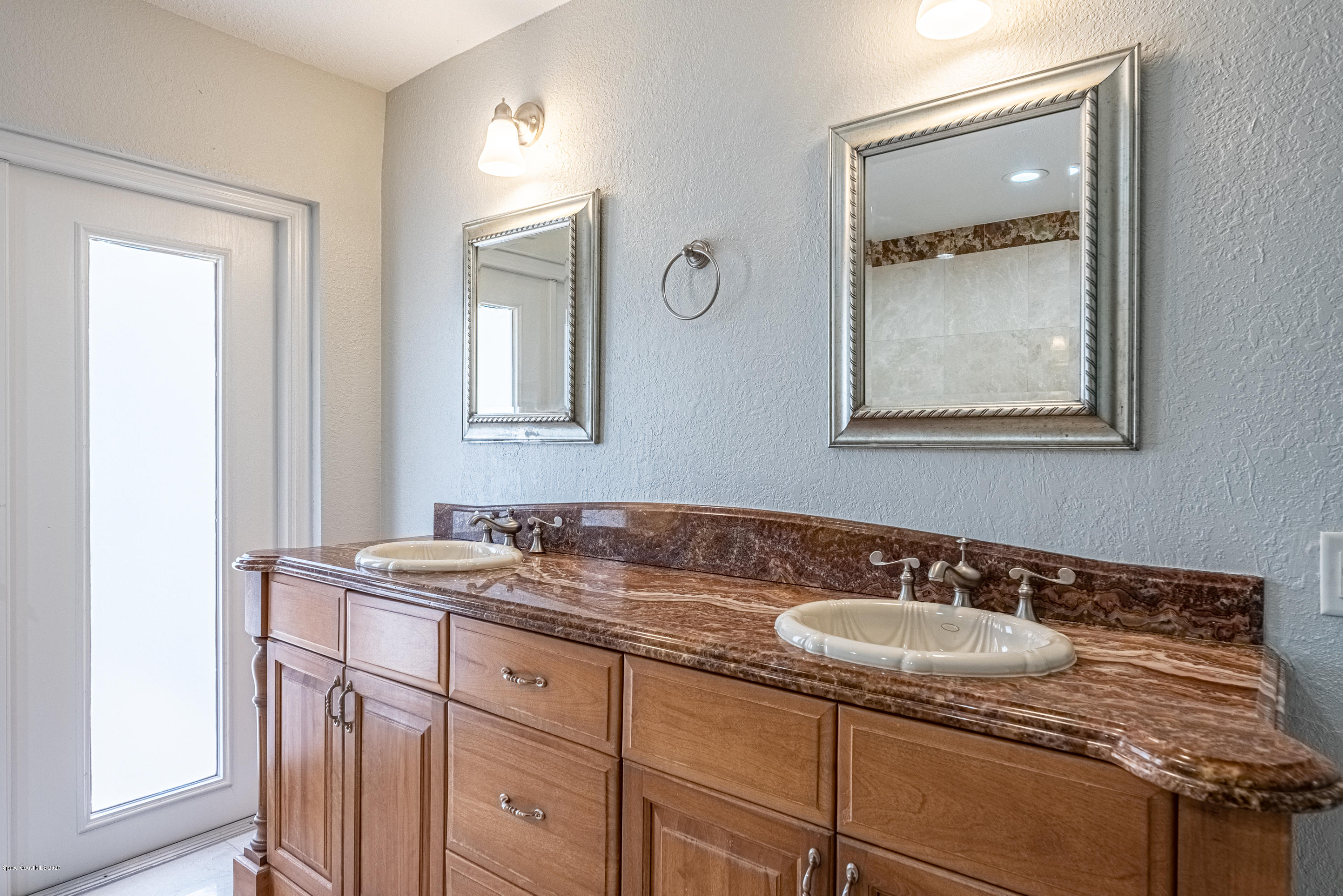 4300 Pinewood Road Melbourne, FL 32934 - Photo 26 of 60 a bathroom with a sink and a mirror