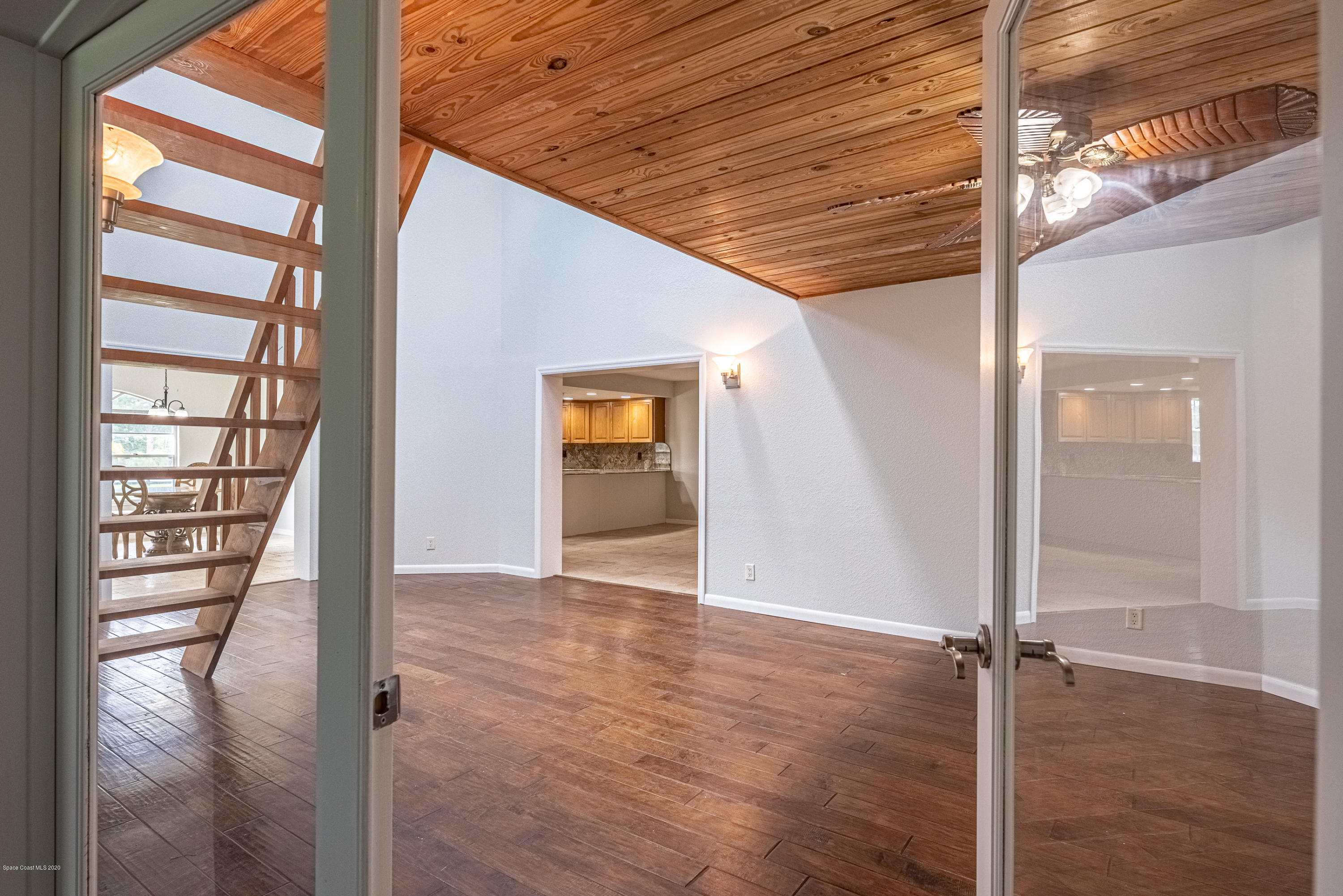 4300 Pinewood Road Melbourne, FL 32934 - Photo 36 of 60 a view of an empty room with wooden floor and a window