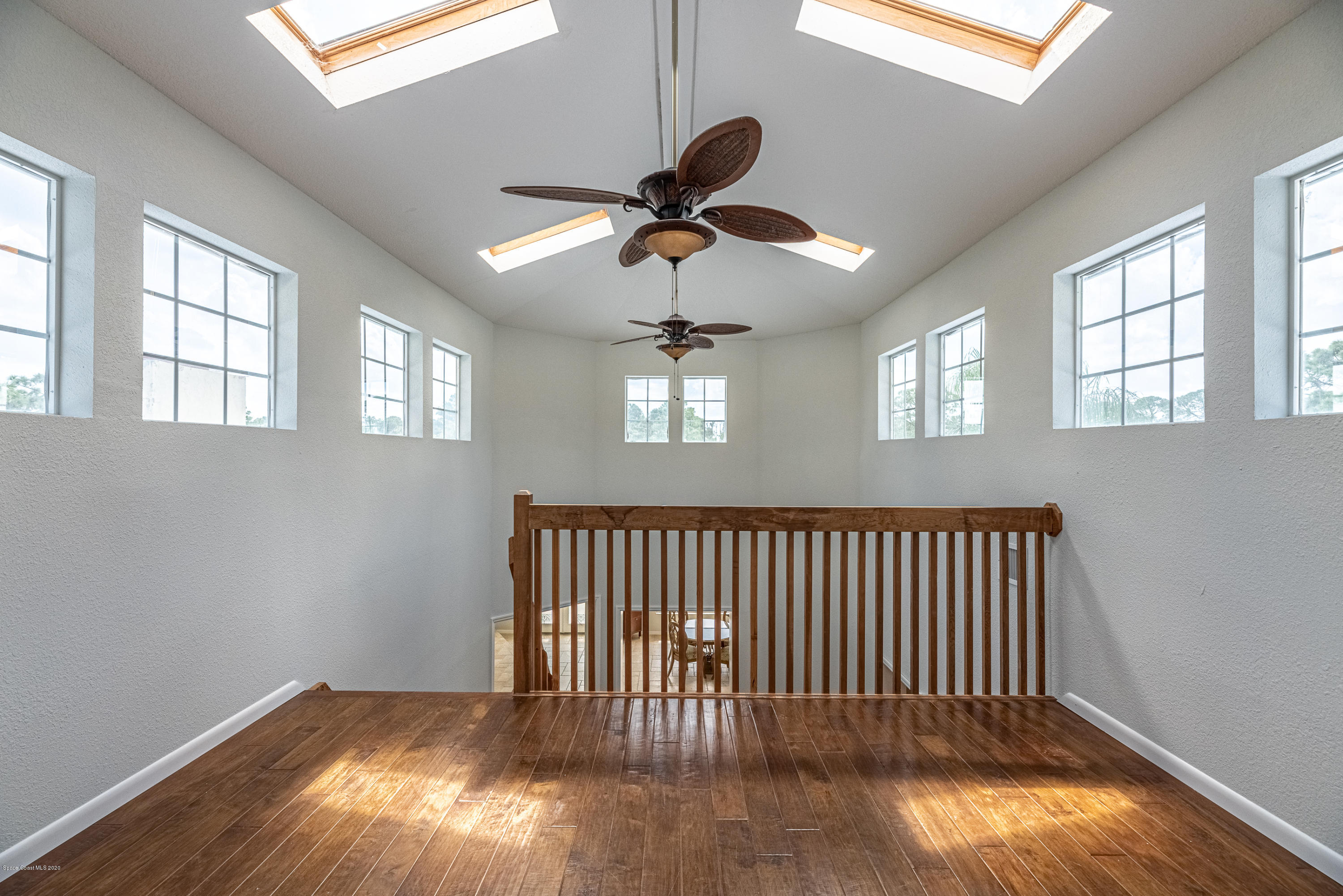 4300 Pinewood Road Melbourne, FL 32934 - Photo 38 of 60 a view of staircase with wooden floor and fan