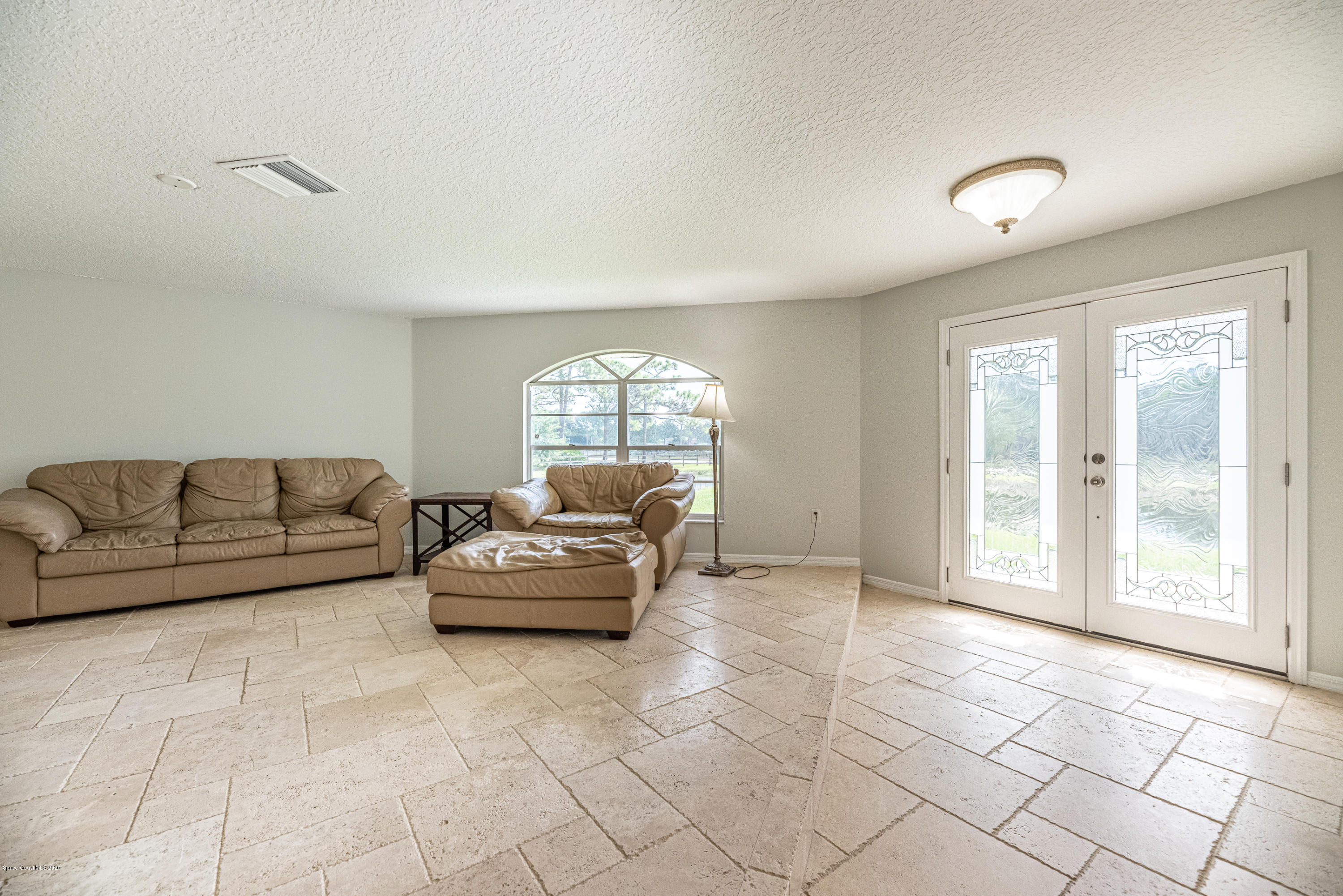 4300 Pinewood Road Melbourne, FL 32934 - Photo 9 of 60 a living room with furniture and a large window
