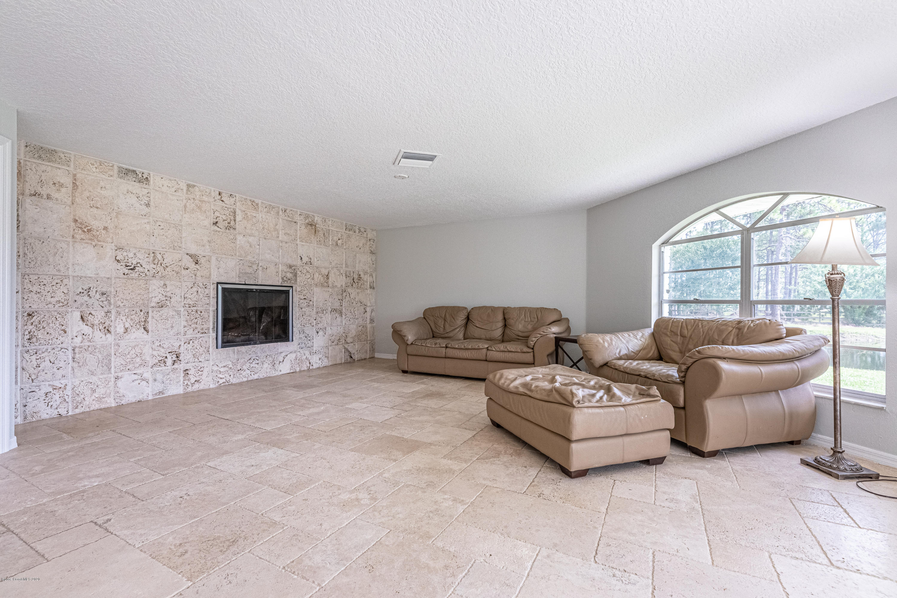 4300 Pinewood Road Melbourne, FL 32934 - Photo 10 of 60 a living room with furniture and a flat screen tv