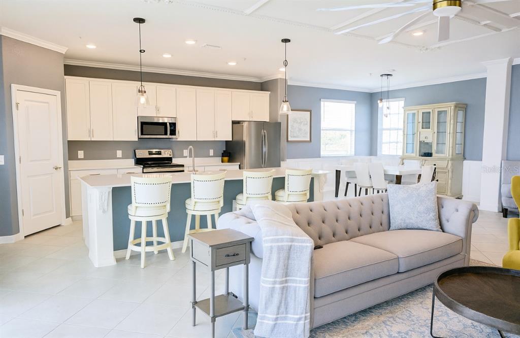 14132 Poppy Fld Loop, Unit 4022 Punta Gorda, FL 33955 - Photo 3 of 17 a living room with stainless steel appliances furniture and a view of kitchen