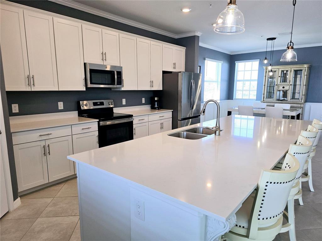 14132 Poppy Fld Loop, Unit 4022 Punta Gorda, FL 33955 - Photo 7 of 17 a kitchen with stainless steel appliances granite countertop a white cabinets