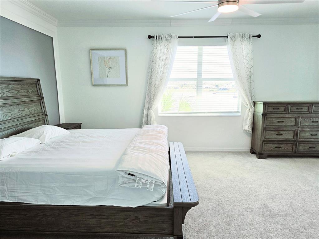 14132 Poppy Fld Loop, Unit 4022 Punta Gorda, FL 33955 - Photo 9 of 17 a bedroom with a bed and a window