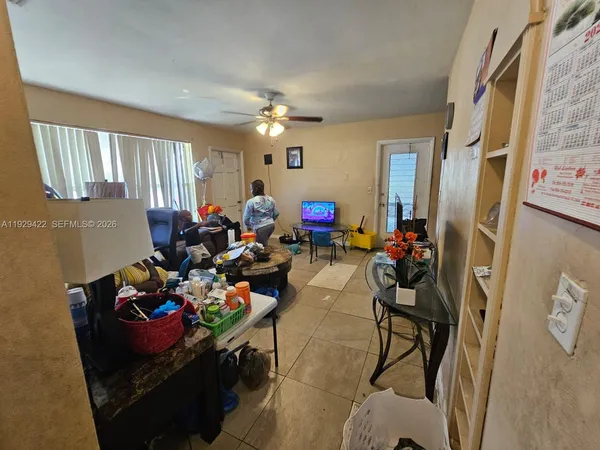 a living room with furniture chess floor and a window