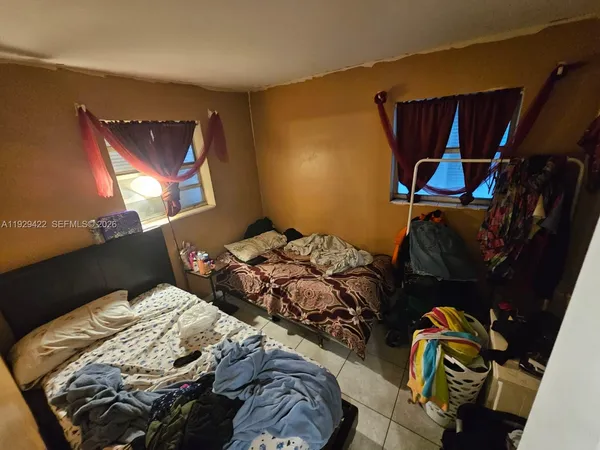 a bedroom with a bed and window