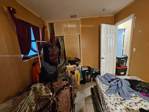 a bedroom with furniture and a closet