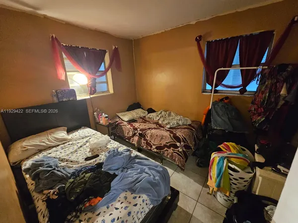 a bed sitting in a bedroom next to a lamp