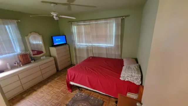 a bedroom with a bed a couch and dresser