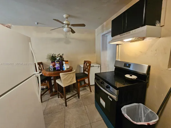 a kitchen with a table and chairs