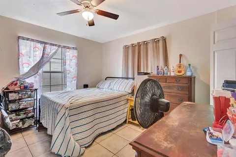 a bedroom with a bed and window