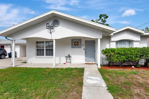 a front view of a house with a yard and porch