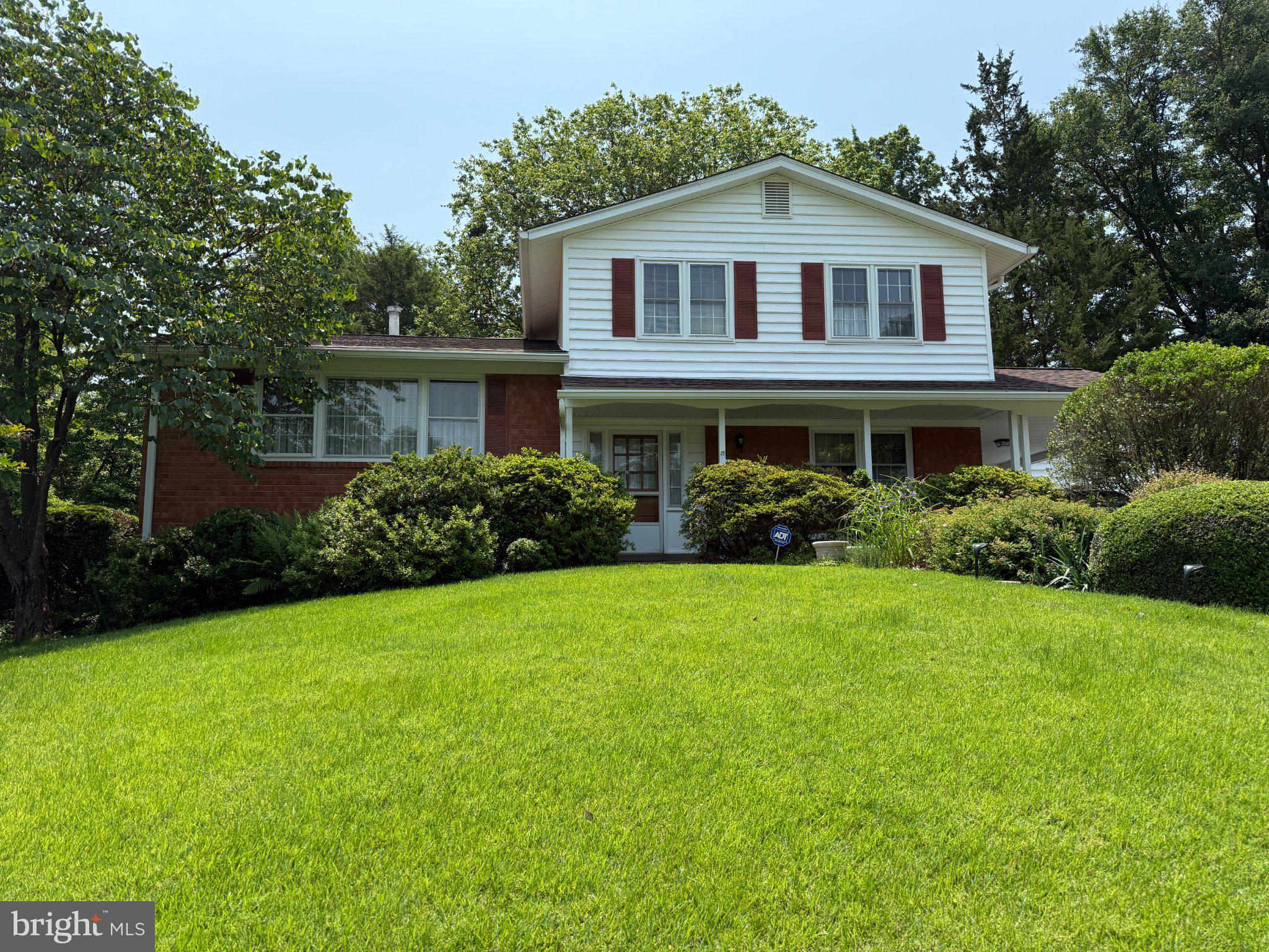 Charming home on a lush green hill.