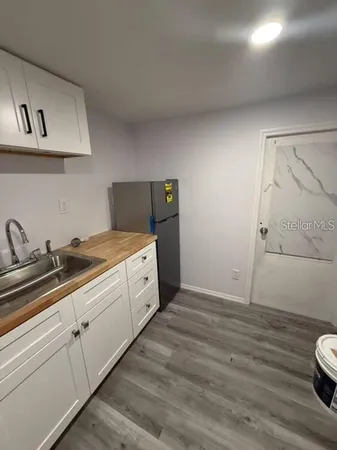 a kitchen with a sink and cabinets