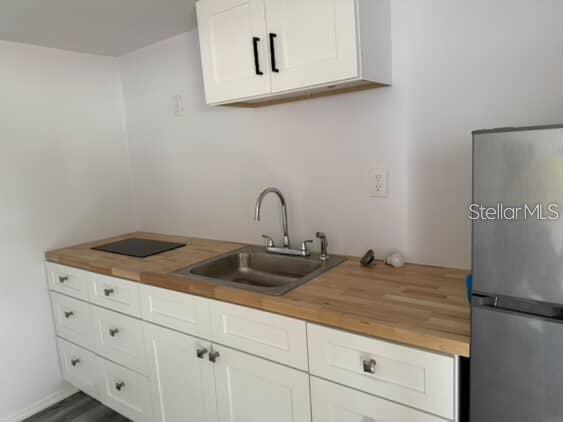 5500 North Rome Avenue, Unit 29 Tampa, FL 33603 - Photo 2 of 10 a bathroom with a sink and cabinets